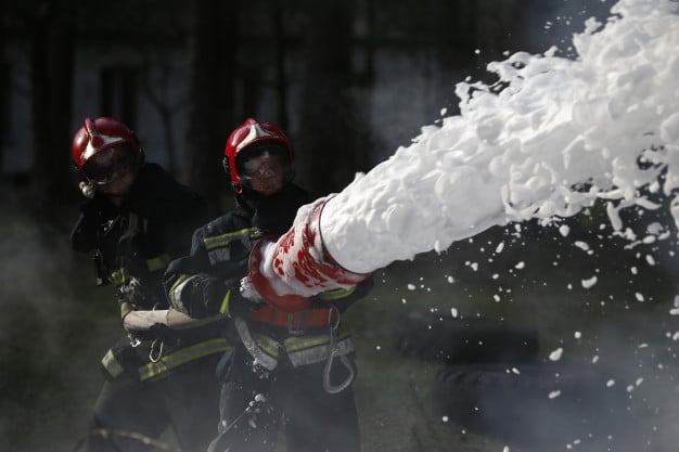 extinguishing-fire-firemen-are-working-fill-foam-with-fire-resolute-firefighters-fight-fire_186673-1